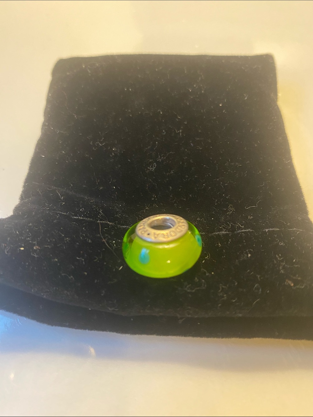 Green bead with blue dots